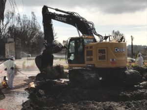 State contractors remove debris from a property in Malibu destroyed by the Woolsey Fire.