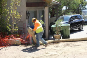 Work crews install fiber logs to prevent erosion on property in Malibu cleared of debris by state contractors.