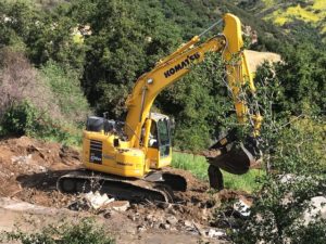 Excavator working on debris