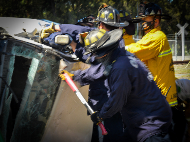 Firefighters Work to Access "Victim" through Car
