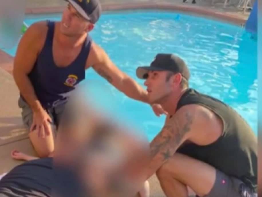 Firefighters perform CPR on a young boy