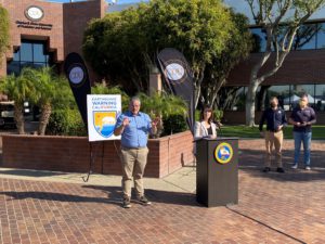 Christina Curry from Cal OES, standing at podium
