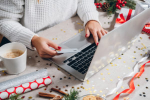 woman shopping on her laptop holding a credit card