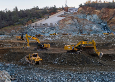 Heavy equipment work continues Wednesday morning March 1, 2017 to remove the huge debris field in the diversion pool at the base of the damaged Oroville Dam spillway.