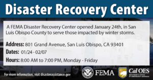 "Disaster Recovery Center" with the address and hours listed in the foreground and an image of FEMA trailers in the background.