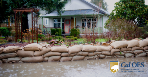 Home with sandbags in front of flood waters and the Cal OES logo.
