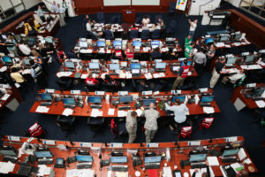 Overhead photo of the California State Operations Center with tiered desks in the circular room.
