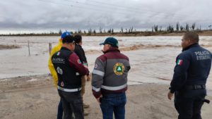 Emergency management officials surveying storm damage from Hurricane Hilary.