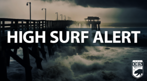 A photo of a dark pier with a menacing wave crashing into it. Text on screen reads, "HIGH SURF ALERT" A Cal O E S logo is at the bottom right.