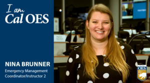 A photo of Nina Brunner smiling in the State Operations Center. To her left is a blue graphic bar reading, I AM Cal OES, Nina Brunner Emergency Services Coordinator/Instructor 2.
