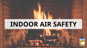 A picture of wood burning in a fireplace. A white rectangle with black text that reads "Indoor Air Safety."
