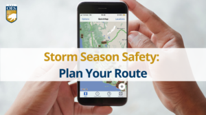 An image of hands holding a smart phone with the CalTrans QuickMap app on screen. Text reads "Storm Season Safety: Plan Your Route."