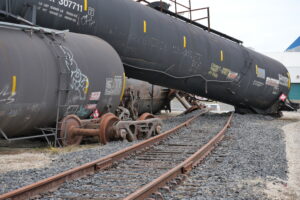 The photo shows derailed tankers positioned at elevated angles at the Hazmat Derailment Training Site in Roseville. 