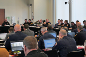 edited photo of group of chiefs sitting at table