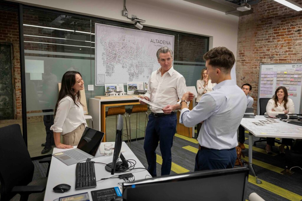 Governor newsom in an office talking to people