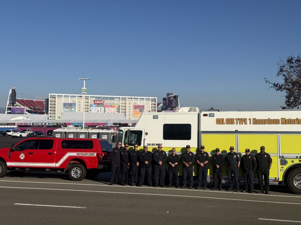 Multiple fire personnel standing in front of fire engines at Levi's Stadium