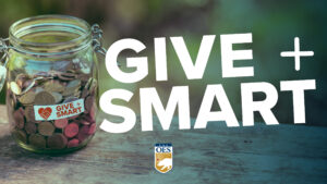 A jar of coins sits on a table with the "give smart" in large text next to the jar.