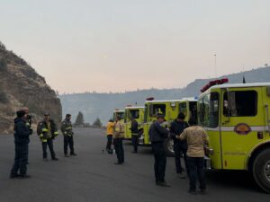 several yellow OES trucks